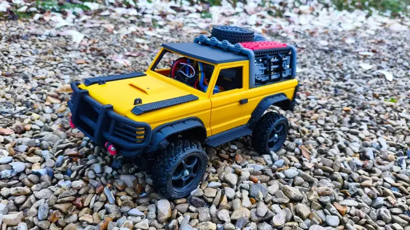 Yellow truck 3/4 front on gravel