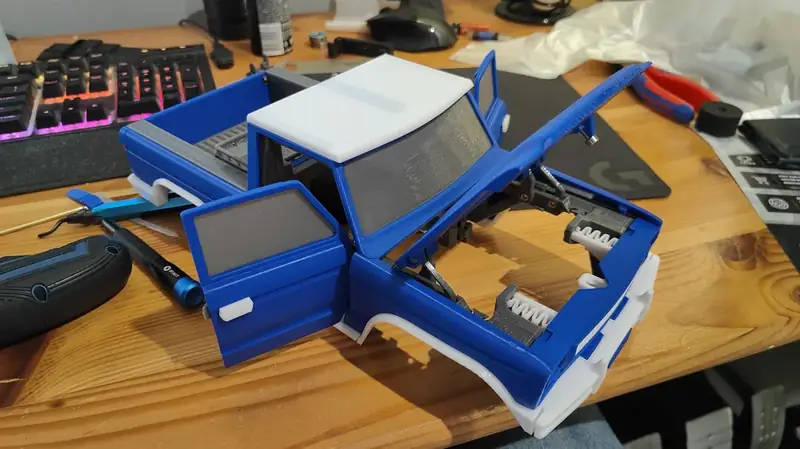 Blue body with all doors open on desk